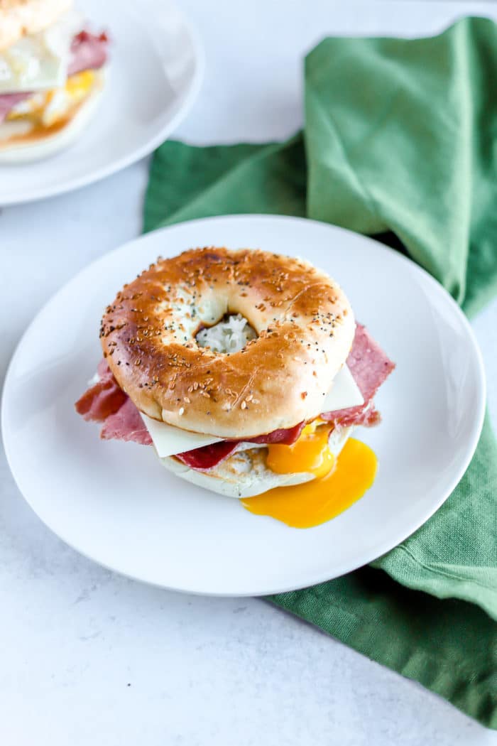 How to make a bagel sandwich. St. Patrick's Day isn't complete without a little hangover breakfast sandwich. So, why not make it festive with this Reuben Breakfast Sandwich?