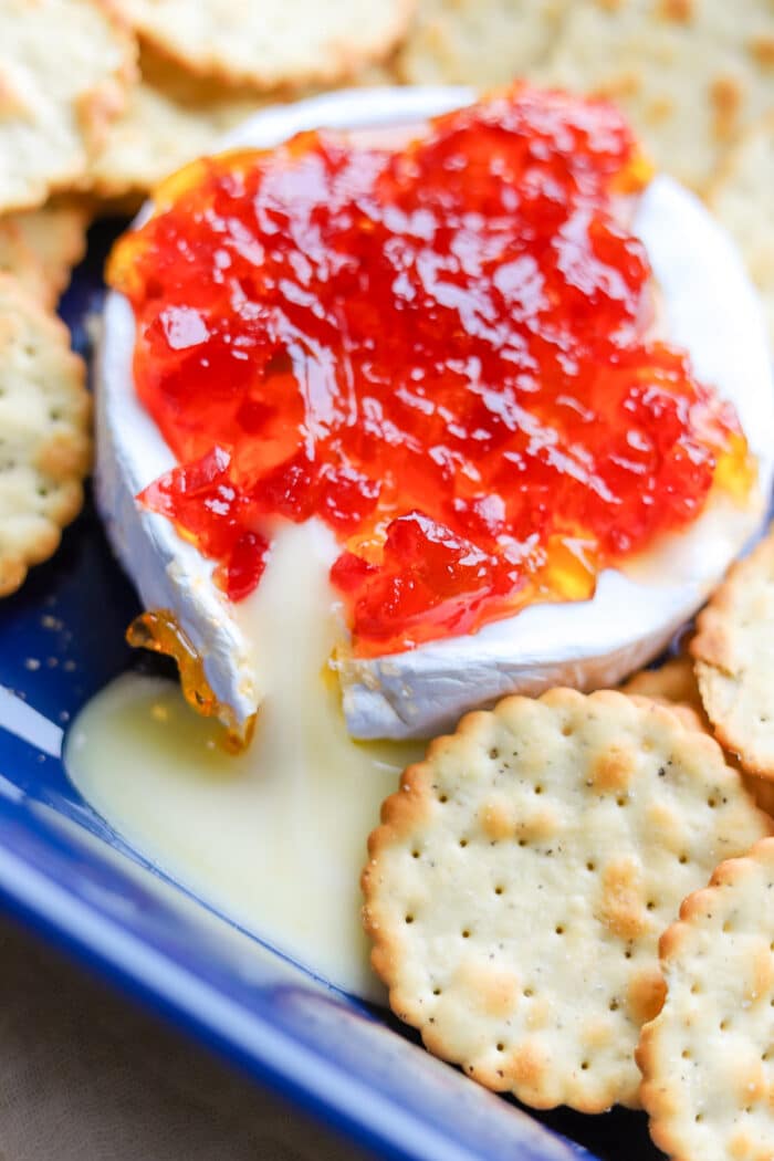Baked brie with pepper jelly is one of my favorite winter appetizer recipes! It is so easy to make and always hits the spot.