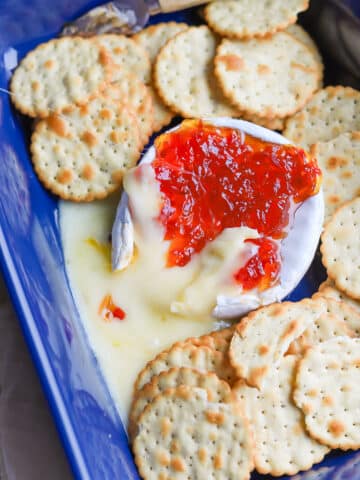 Baked brie with pepper jelly is one of my favorite winter appetizer recipes! It is so easy to make and always hits the spot.