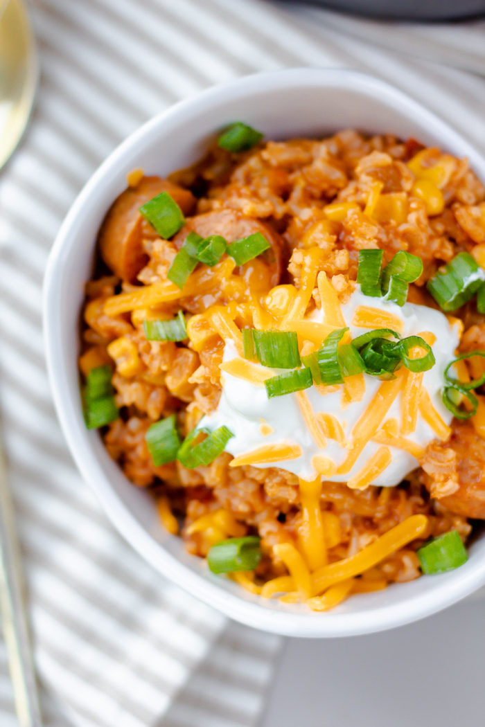 This easy sausage and rice casserole is one of my favorite healthy one pot dinner recipes to make. Whether you're looking for a healthy dinner recipe for a family or a meal prep recipe, this is the one. I like to top mine with greek yogurt, cheese and green onion to treat it like a chili. by bits and bites #onepotdinners #sausageandrice 