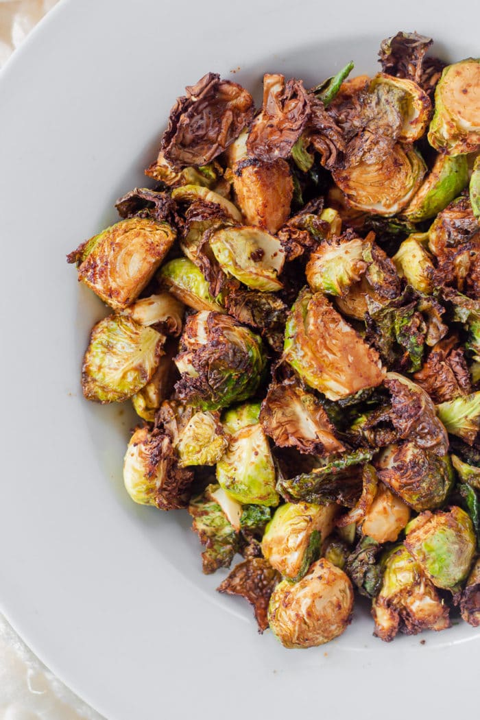 Honey Sriracha Brussels Sprouts in the air fryer is the best way to cook brussels sprouts. It's sweet, yet spicy, and such a great fall side dish recipe. Air Fryer brussels sprouts give you the perfect sprouts every time, they turn out crispy and way better than roasted brussels sprouts.