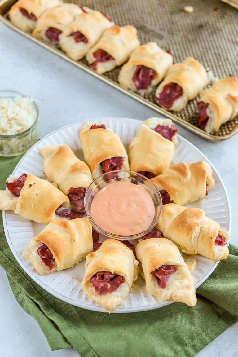 Reuben roll ups are one of my favorite easy St. Patrick's Day appetizer recipes. Dip them in thousand island dressing for a delicious crescent roll recipe!
