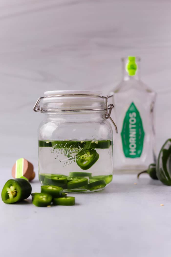 homemade jalapeno-infused tequila is so easy to make and is the best for homemade spicy margaritas.