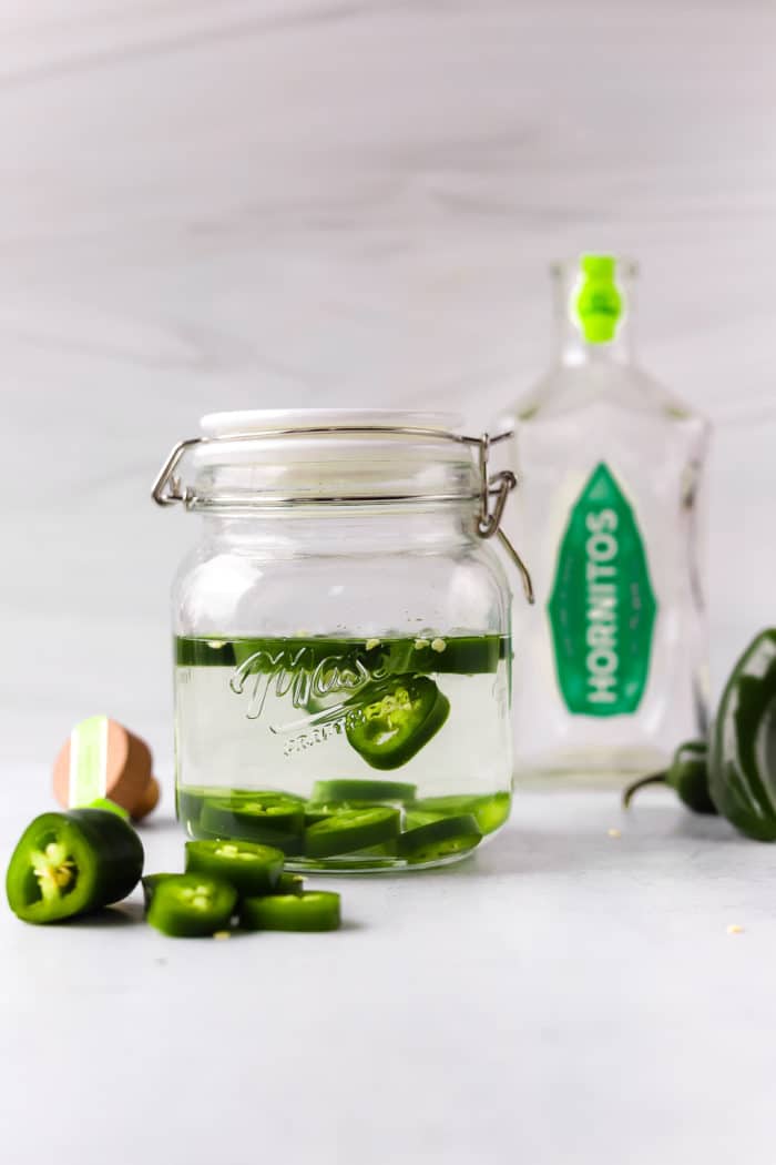 homemade jalapeno-infused tequila is so easy to make and is the best for homemade spicy margaritas.