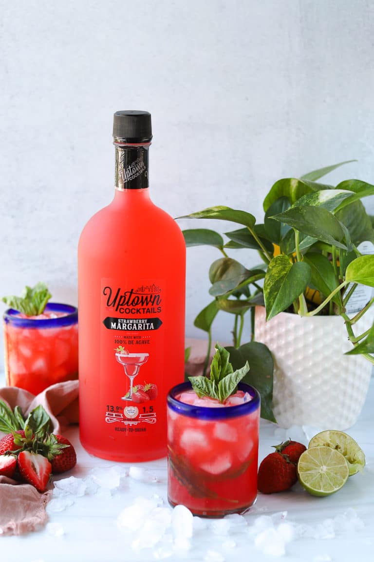 I love adding fresh herbs into margarita recipes, and this Uptown Cocktails Strawberry Margarita with fresh basil is such an easy margarita recipe!