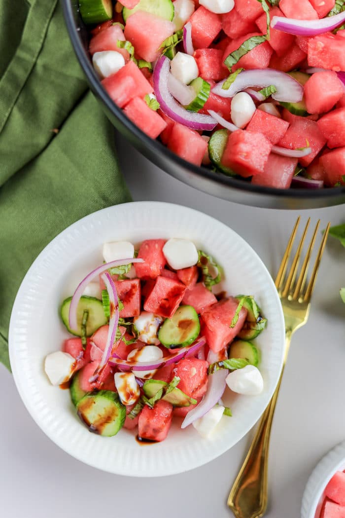 What dressing goes on watermelon salad? I prefer balsamic dressing or a balsamic reduction. With watermelon and cucumbers, the balsamic reduction gets watered down to the perfect thickness, whereas balsamic dressing is already pretty runny.