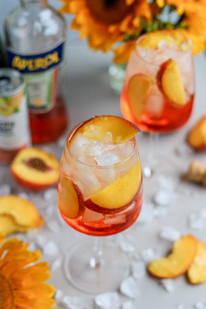 I love a good Aperol Spritz, especially in the summertime. But, to add a fun and summery twist to the traditional Aperol Spritz recipe, meet the Peach Aperol Spritz!