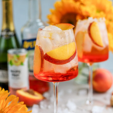 I love a good Aperol Spritz, especially in the summertime. But, to add a fun and summery twist to the traditional Aperol Spritz recipe, meet the Peach Aperol Spritz!