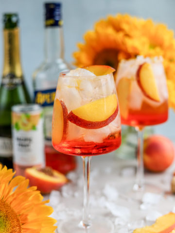 I love a good Aperol Spritz, especially in the summertime. But, to add a fun and summery twist to the traditional Aperol Spritz recipe, meet the Peach Aperol Spritz!