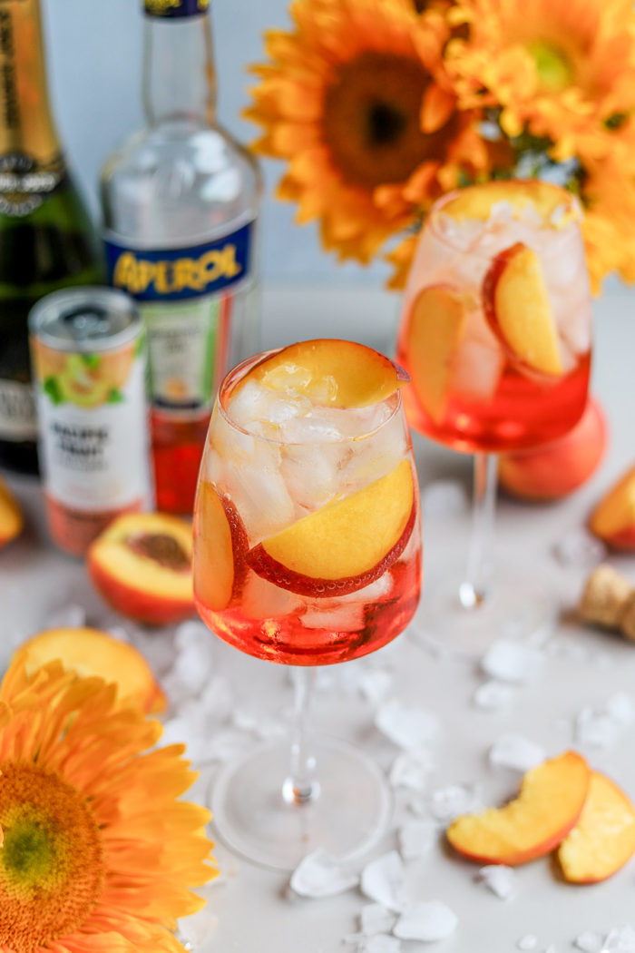 I love a good Aperol Spritz, especially in the summertime. But, to add a fun and summery twist to the traditional Aperol Spritz recipe, meet the Peach Aperol Spritz!