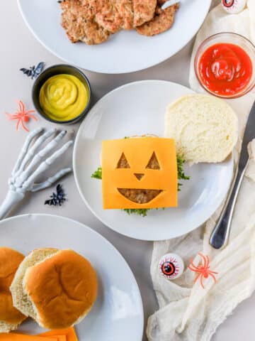 These Halloween burgers are so cute and so easy to make! If you're looking for easy Halloween food ideas, these Jack-O-Lantern burgers are it.