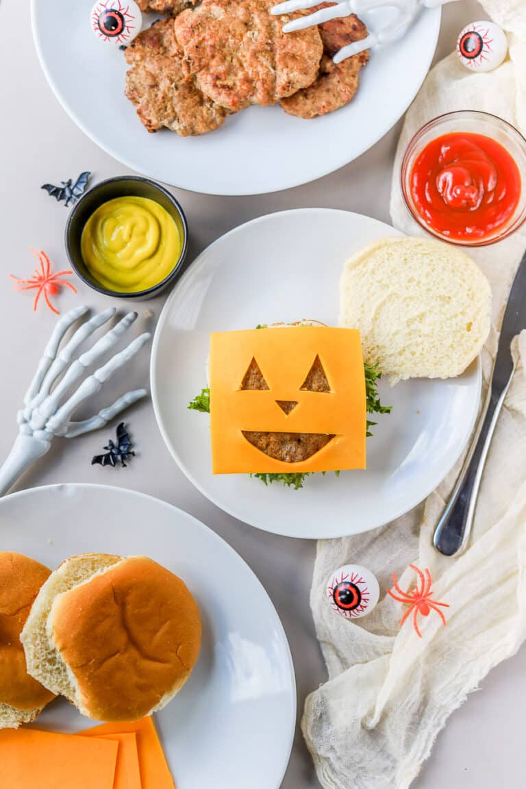 These Halloween burgers are so cute and so easy to make! If you're looking for easy Halloween food ideas, these Jack-O-Lantern burgers are it.