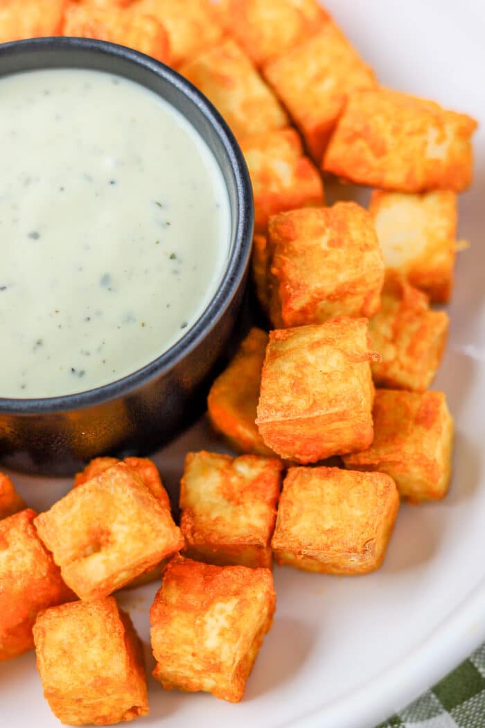 buffalo tofu nuggets served with a side of ranch dressing to dip it in.