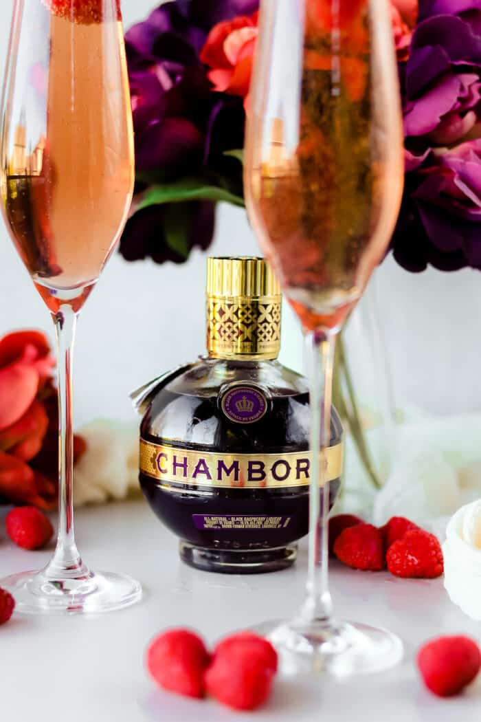 When you're making drinks for any holiday, you can never go wrong with a champagne cocktail. This raspberry champagne cocktail recipe with Chambord is so perfect for almost any holiday!