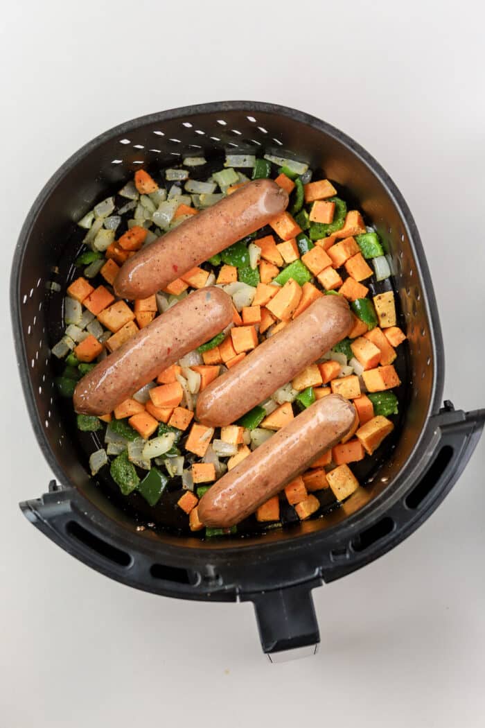 If you're looking for a quick and healthy air fryer recipe idea, this air fryer chicken sausage and veggies is perfect. It's done in under 20 minutes, including prep time!