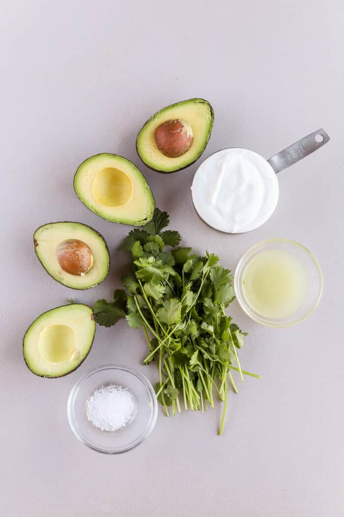This avocado cream sauce with greek yogurt is so simple to put together. It's so full of flavor and perfect for tacos, fish, chicken or salads. Let's make it!