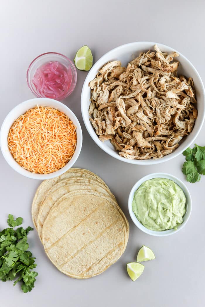 These crispy chicken tacos are so delicious and so easy to make! Pair them with an avocado crema and you have the perfect weeknight meal or game day appetizer.