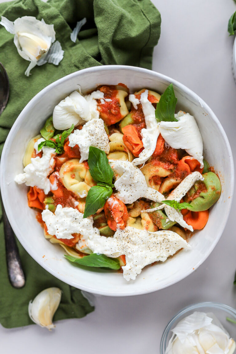 tortellini pomodoro with burrata on top.